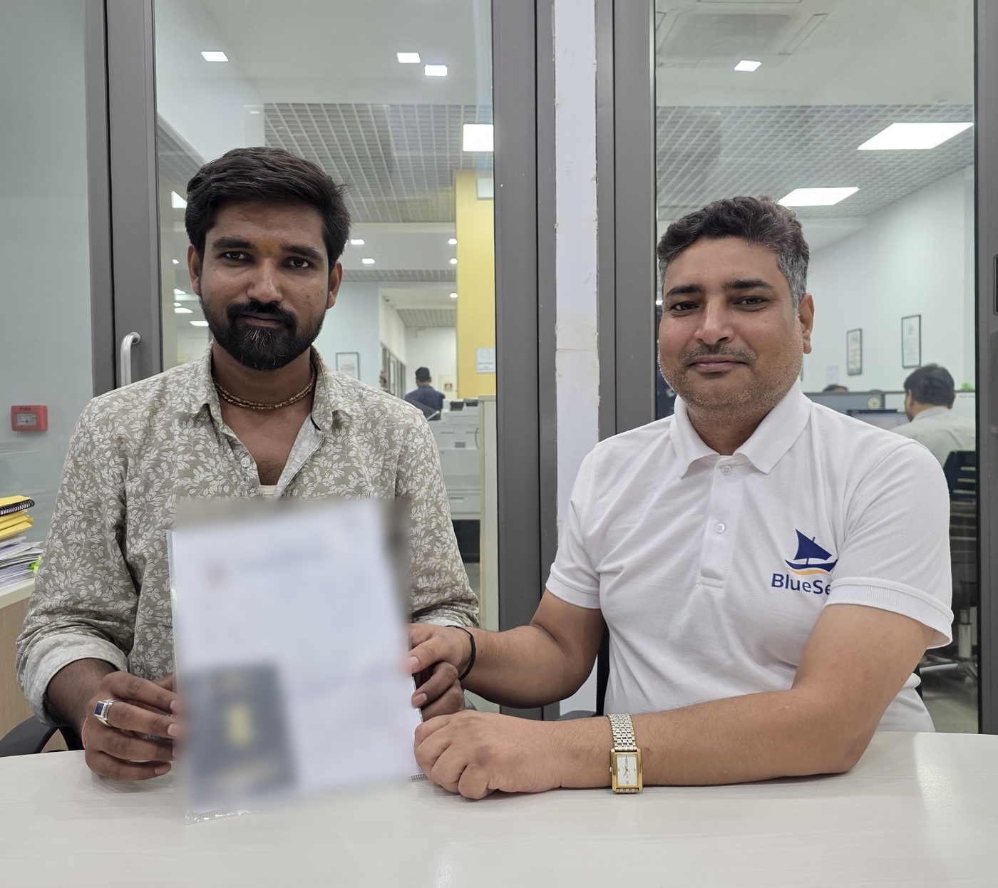 A BlueSeas candidate receiving his signed offer letter and work visa from a BlueSeas advisor